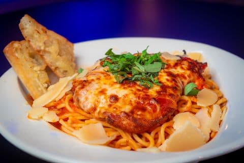 Chicken parmesan over spaghetti with garlic bread