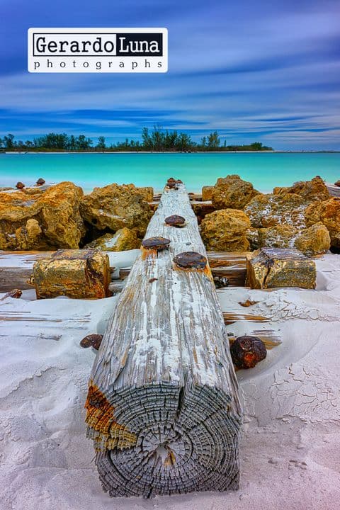 Distressed pier on a pristine beach