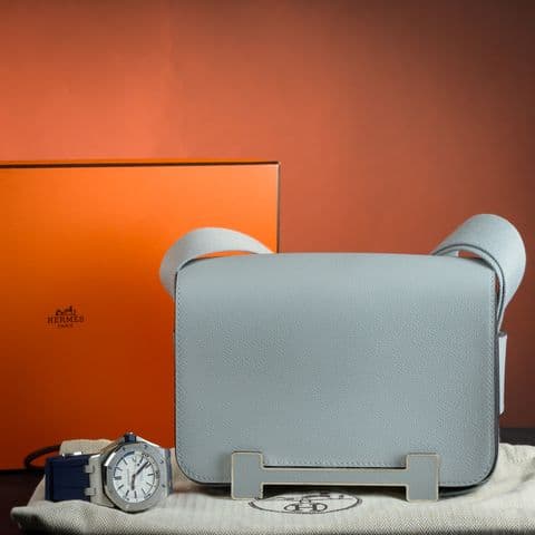 Hermes leather bag styled with a luxury watch
