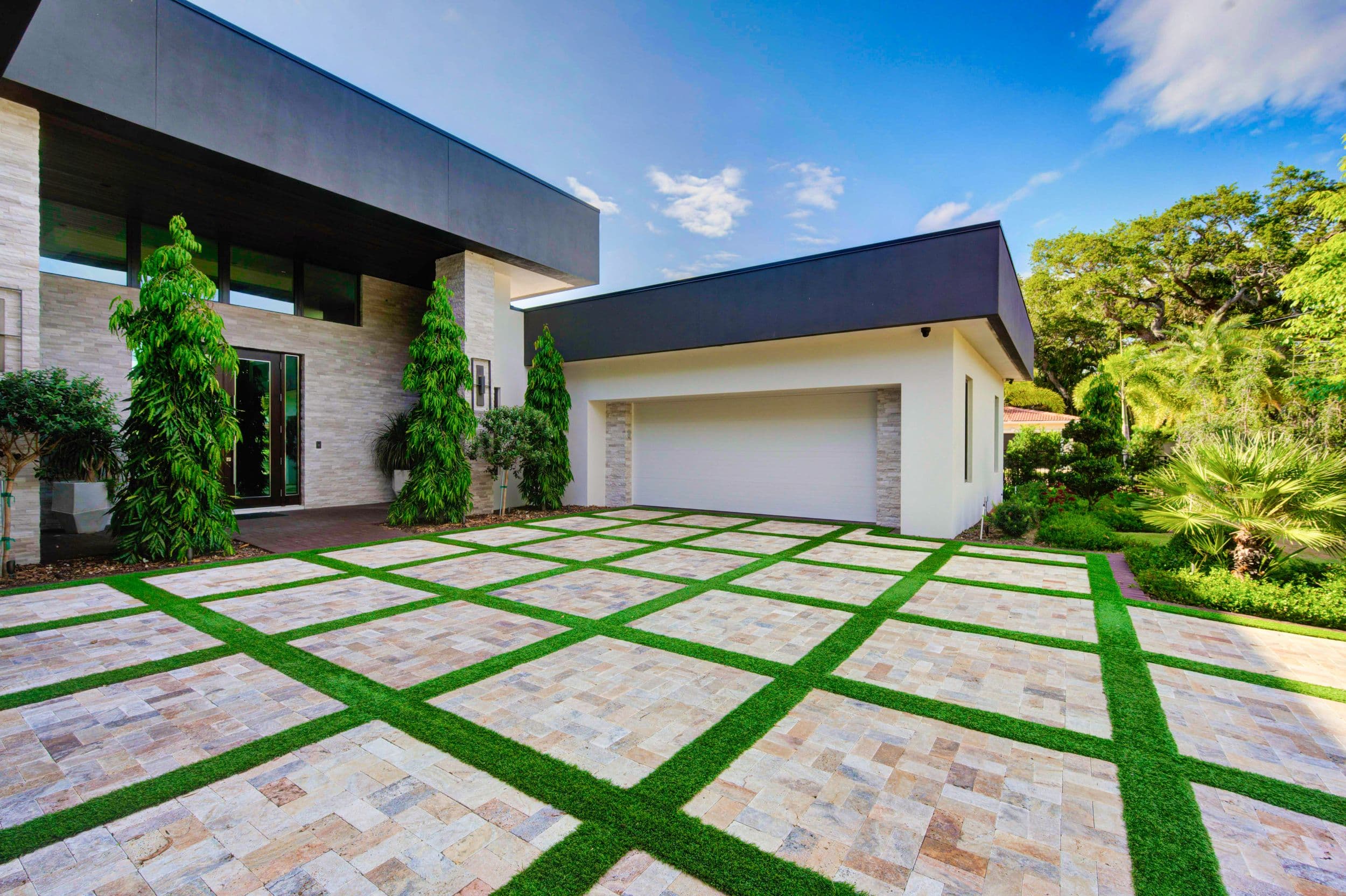 Custom landscaping and driveway with grass stripes