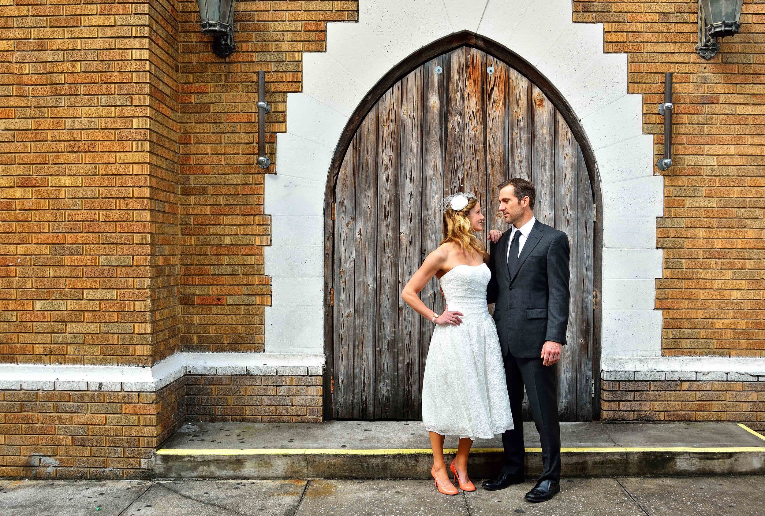 Couple posing in front of distressed door