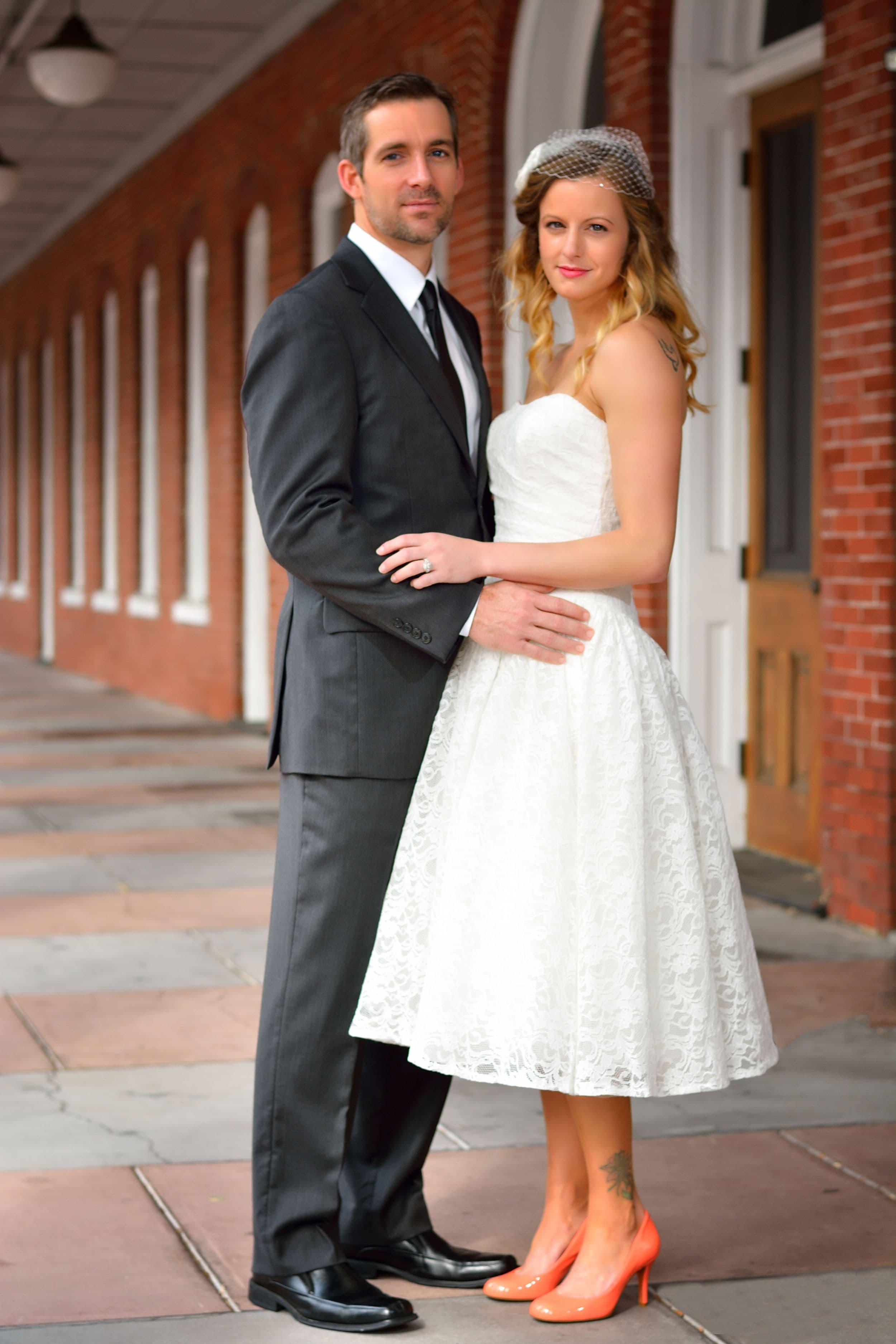 Couple posing in front of bricks in Ybor City