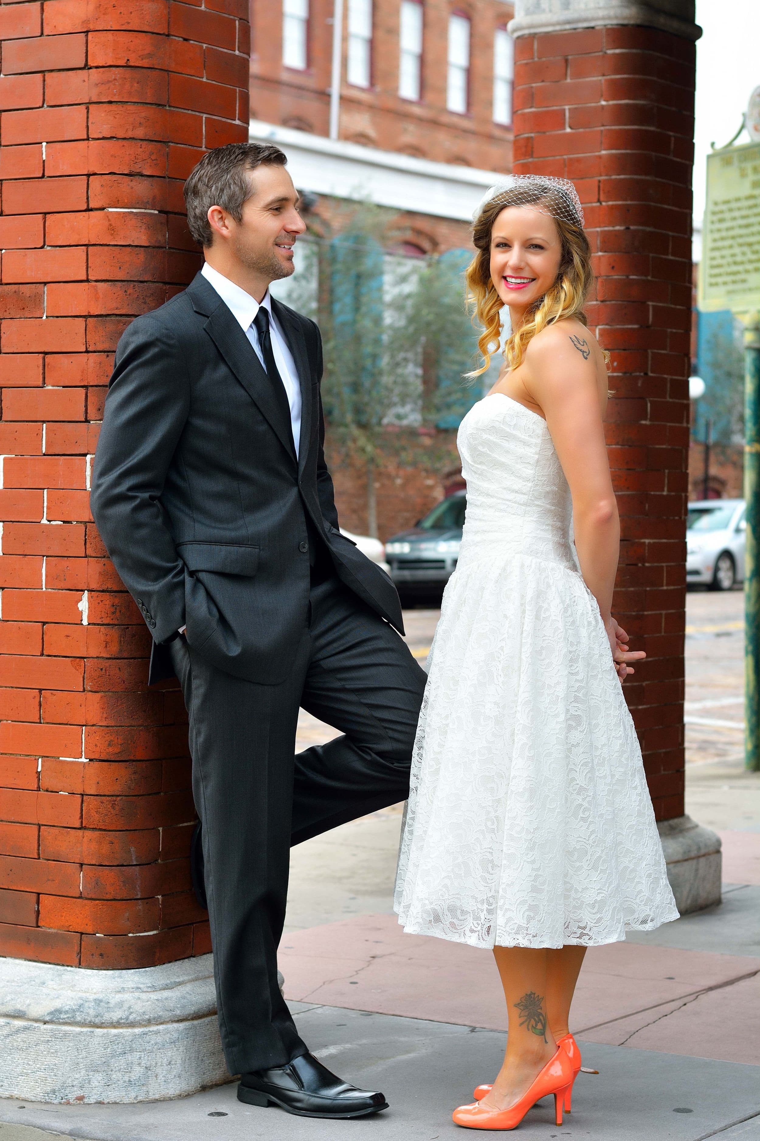 Couple posing in front of brick columns