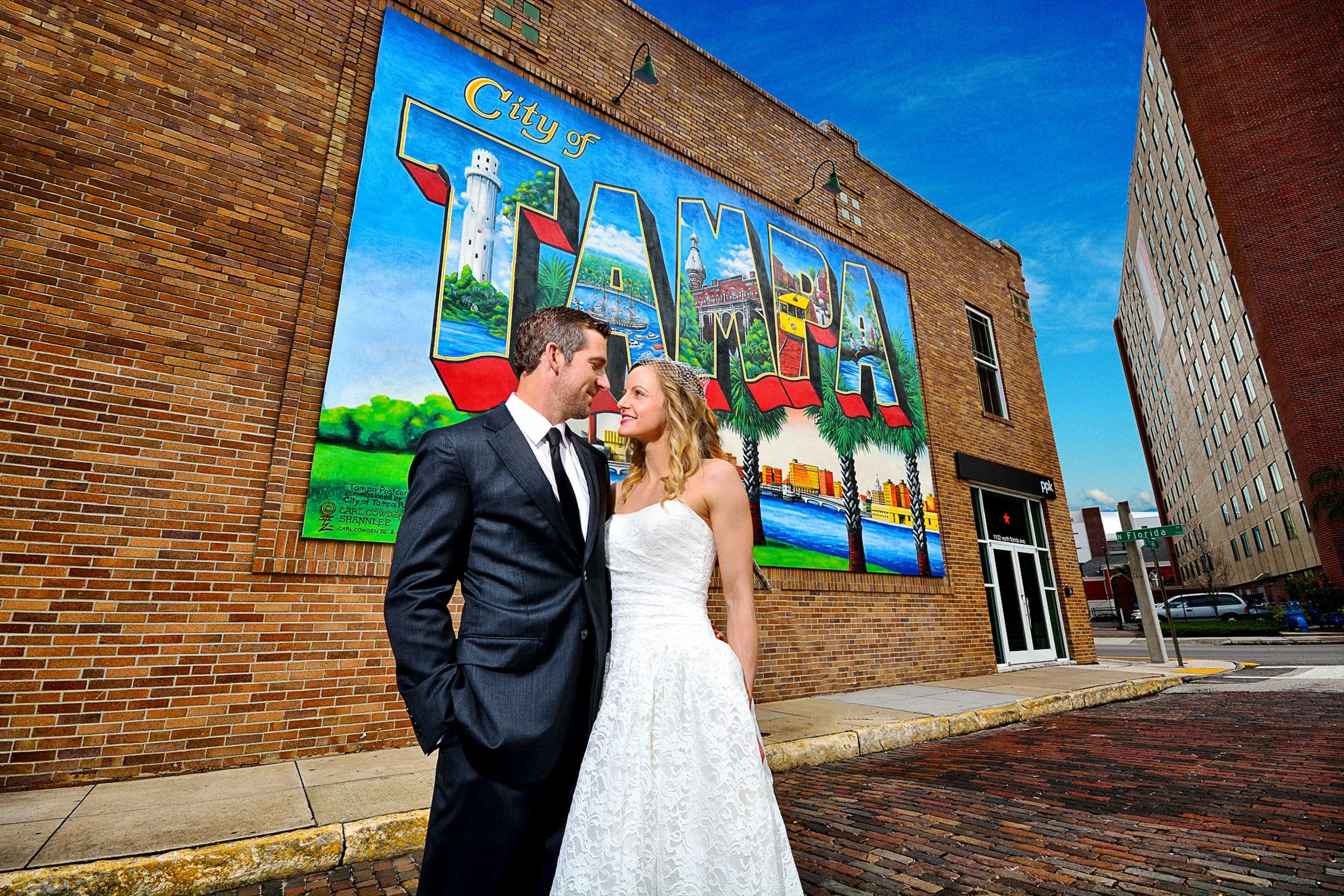 Couple in front of Tampa mural and brick road